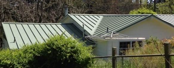 Custom metal roofing with variable, angled pitch.