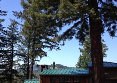 Custom metal roofing on a rustic house that blends into landscape.
